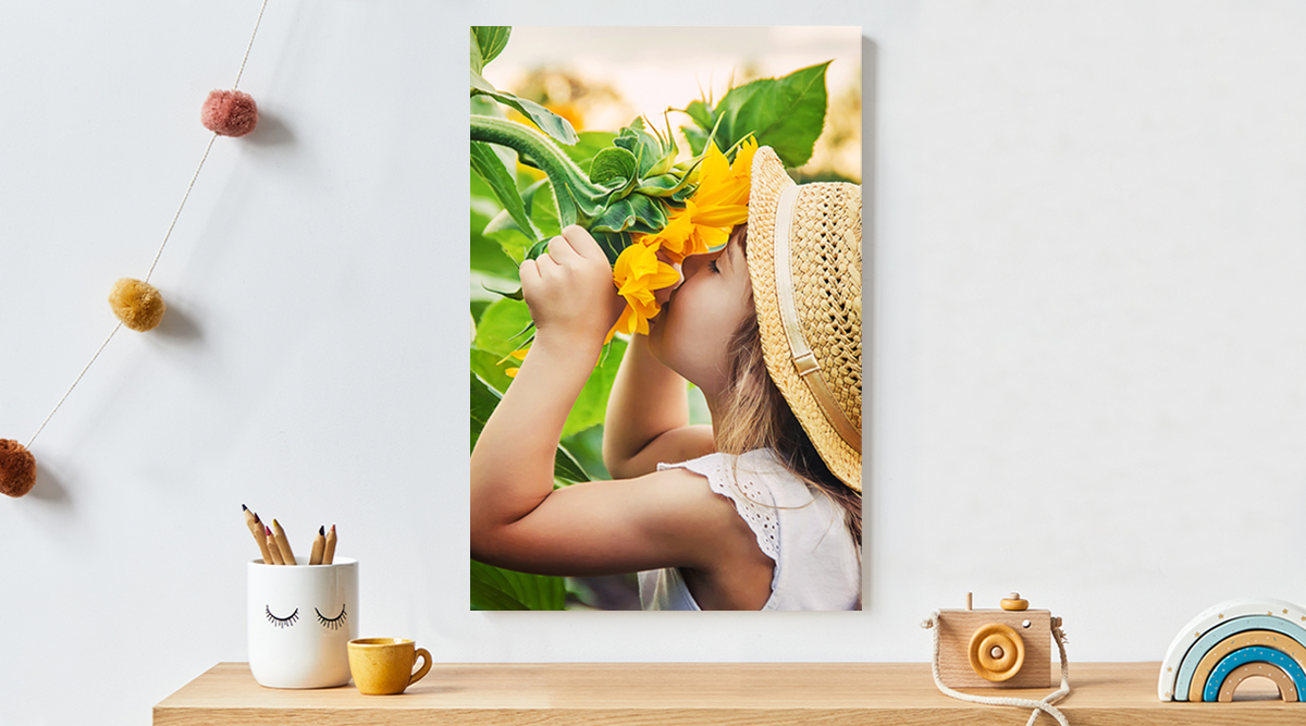 A picture of a little girl burying her face in a big sunflower