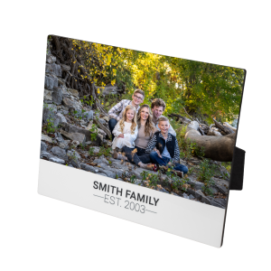 Photo of mom with her three sons and one daughter printed on a hardboard surface.