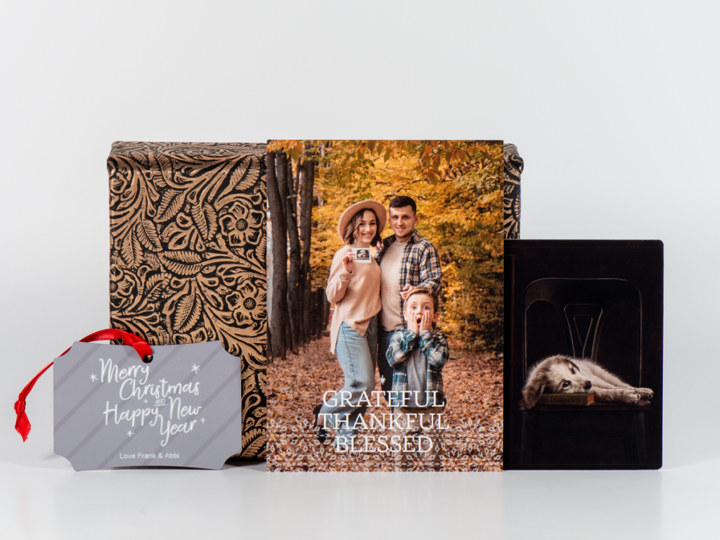 McKenna's Full Material Wrap Image Box with holiday ornament, holiday press card, and photo print sitting in front of the box.
